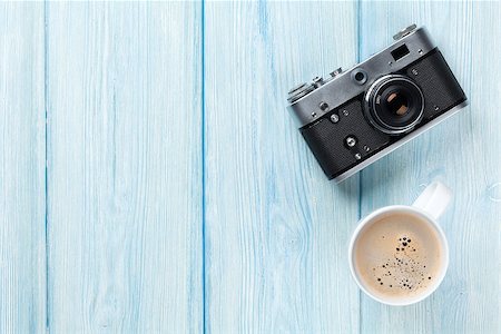 Travel camera and coffee cup on wooden table. Top view with copy space Stock Photo - Budget Royalty-Free & Subscription, Code: 400-08294971