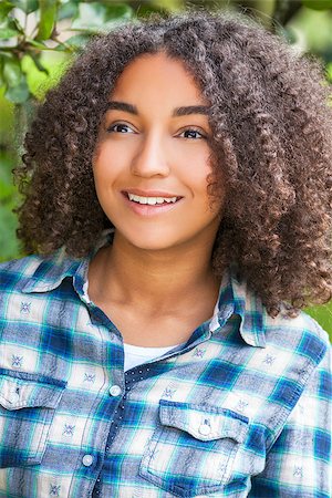 simsearch:400-04068097,k - Outdoor portrait of beautiful happy mixed race African American girl teenager female child smiling with perfect teeth Stockbilder - Microstock & Abonnement, Bildnummer: 400-08295343