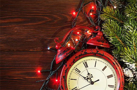 Christmas alarm clock, tree branch and lights on wooden background. View with copy space Stock Photo - Budget Royalty-Free & Subscription, Code: 400-08295828