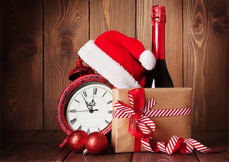Christmas gift box, alarm clock, santa hat and champagne bottle Stock Photo - Budget Royalty-Free & Subscription, Code: 400-08295822