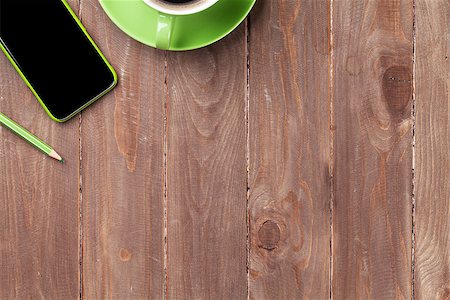 simsearch:400-08252729,k - Office wooden desk with smartphone and coffee cup. Top view with copy space Stock Photo - Budget Royalty-Free & Subscription, Code: 400-08295834