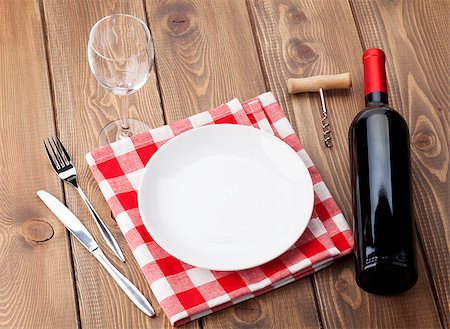 simsearch:400-07937813,k - Table setting with empty plate, wine glass and red wine bottle. Top view over rustic wooden table background Photographie de stock - Aubaine LD & Abonnement, Code: 400-08295899