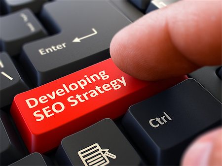 simsearch:400-07045079,k - Developing SEO Strategy Button. Male Finger Clicks on Red Button on Black Keyboard. Closeup View. Blurred Background. Stock Photo - Budget Royalty-Free & Subscription, Code: 400-08296584