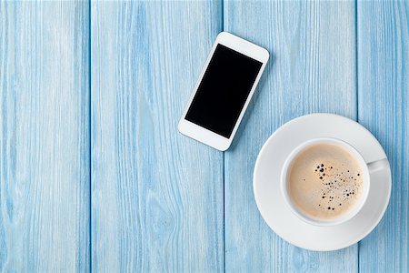 Coffee cup and smartphone on wooden table background. Top view with copy space Stock Photo - Budget Royalty-Free & Subscription, Code: 400-08296747