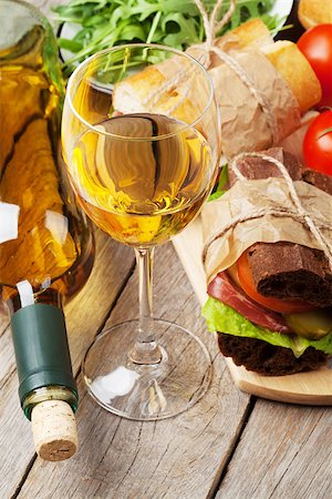 simsearch:400-07937807,k - White wine glass and sandwiches on wooden table Photographie de stock - Aubaine LD & Abonnement, Code: 400-08296741