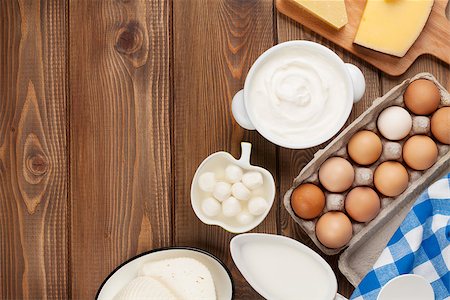simsearch:400-08296754,k - Dairy products on wooden table. Sour cream, milk, cheese, egg, yogurt and butter. Top view with copy space Stock Photo - Budget Royalty-Free & Subscription, Code: 400-08296756