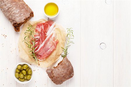 simsearch:400-07481817,k - Italian prosciutto with ciabatta and olives on white wooden table. Top view with copy space Stock Photo - Budget Royalty-Free & Subscription, Code: 400-08296758