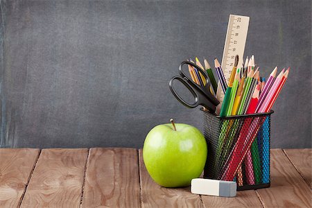 simsearch:400-08289551,k - School and office supplies on classroom table in front of blackboard. View with copy space Stock Photo - Budget Royalty-Free & Subscription, Code: 400-08296791