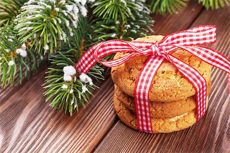 pinecones and ribbons - Christmas gingerbread cookies and tree branch on wooden table Stock Photo - Budget Royalty-Free & Subscription, Code: 400-08296843