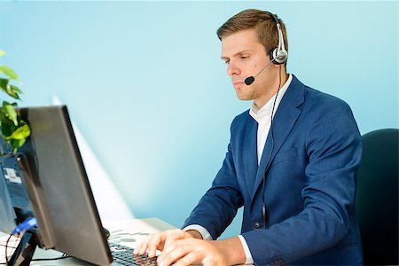 simsearch:400-05710310,k - Young Customer Support Phone Operator with Headset Working on Computer in the Office. Stock Photo - Budget Royalty-Free & Subscription, Code: 400-08297142
