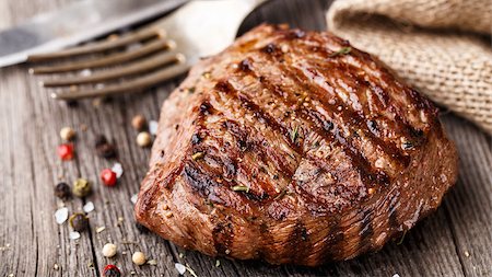 steak knife - Delicious grilled beef steak on a wooden board with spices Photographie de stock - Aubaine LD & Abonnement, Code: 400-08297973