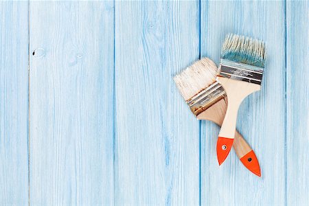 staining wood brush - Paintbrush over blue wood. Top view with copy space Stock Photo - Budget Royalty-Free & Subscription, Code: 400-08298034