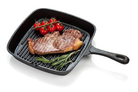 Sirloin steak with rosemary and cherry tomatoes cooking in a frying pan. Isolated on white background Stock Photo - Budget Royalty-Free & Subscription, Code: 400-08298064