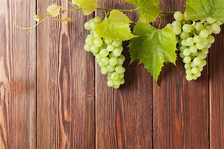 simsearch:400-08110621,k - Bunch of white grapes with leaves on wooden background with copy space Stock Photo - Budget Royalty-Free & Subscription, Code: 400-08298075