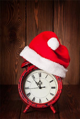 Christmas alarm clock with santa hat on wooden table Stock Photo - Budget Royalty-Free & Subscription, Code: 400-08298107