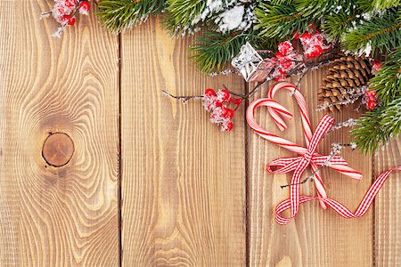 simsearch:400-07824858,k - Christmas wooden background with snow fir tree and candy cane Stock Photo - Budget Royalty-Free & Subscription, Code: 400-08298133