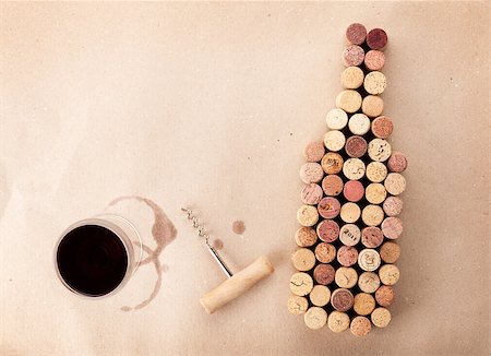 simsearch:400-08730808,k - Wine bottle shaped corks, glass of wine and corkscrew over cardboard paper background. View from above with copy space Stock Photo - Budget Royalty-Free & Subscription, Code: 400-08298166