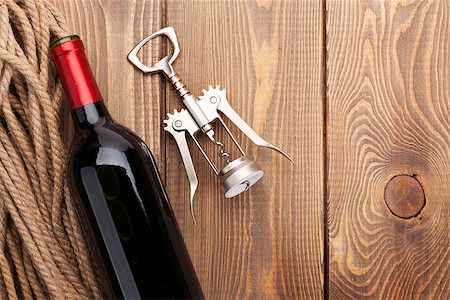 simsearch:400-07933837,k - Red wine bottle and corkscrew on wooden table background. Top view with copy space Stockbilder - Microstock & Abonnement, Bildnummer: 400-08298167