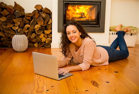 fireplace computer - Beautiful woman working with a laptop at the warmth of the fireplace Stock Photo - Budget Royalty-Free & Subscription, Code: 400-08298437