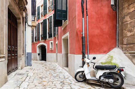 simsearch:400-04693739,k - Retroscooter on colorful narrow street in old town Photographie de stock - Aubaine LD & Abonnement, Code: 400-08298657