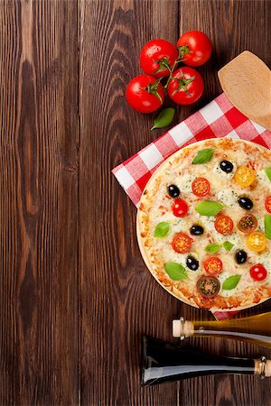 simsearch:400-08960199,k - Italian pizza with cheese, tomatoes, olives and basil on wooden table. Top view with copy space Stock Photo - Budget Royalty-Free & Subscription, Code: 400-08298814