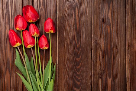 simsearch:400-08036453,k - Red tulips bouquet over wooden table background with copy space Stock Photo - Budget Royalty-Free & Subscription, Code: 400-08298840