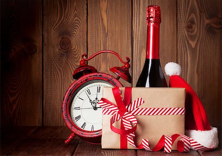 Christmas gift box, alarm clock, santa hat and champagne bottle Stock Photo - Budget Royalty-Free & Subscription, Code: 400-08298886