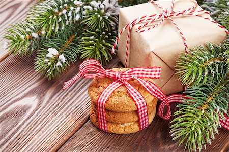 Christmas gingerbread cookies, gift box and tree branch on wooden table Stock Photo - Budget Royalty-Free & Subscription, Code: 400-08298901