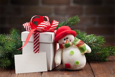 simsearch:400-04241664,k - Christmas gift box, snowman toy, greeting card and fir tree branch on wooden table Stock Photo - Budget Royalty-Free & Subscription, Code: 400-08298914