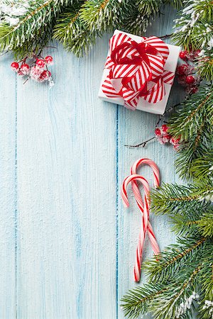 simsearch:400-04241664,k - Christmas gift box, candy cane and fir tree branch on wooden table. Top view with copy space Stock Photo - Budget Royalty-Free & Subscription, Code: 400-08298917