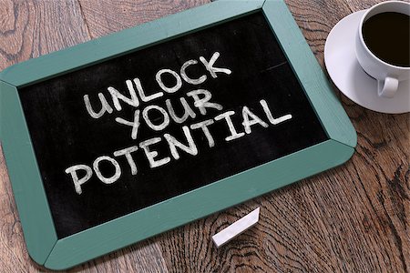 Hand Drawn Unlock Your Potential Concept  on Small Blue Chalkboard. Business Background. Top View. Stock Photo - Budget Royalty-Free & Subscription, Code: 400-08299017