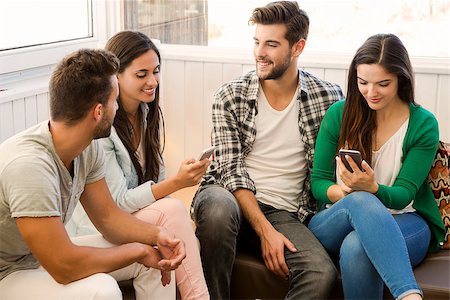 students campus phones - Friends meeting at the local coffee shop and having fun Stock Photo - Budget Royalty-Free & Subscription, Code: 400-08299458