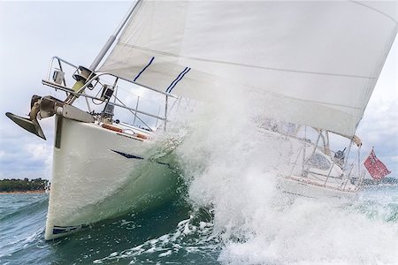 Close up on the bow of a sailboat breaking through a wave Stock Photo - Budget Royalty-Free & Subscription, Code: 400-08299606
