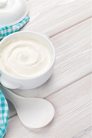 simsearch:400-07825089,k - Sour cream in a bowl on wooden table. Top view with copy space Stockbilder - Microstock & Abonnement, Bildnummer: 400-08299648