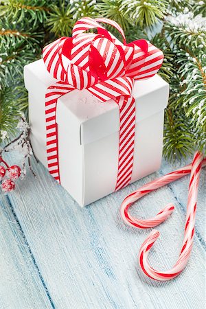 simsearch:400-04241664,k - Christmas gift box, candy cane and fir tree branch on wooden table Stock Photo - Budget Royalty-Free & Subscription, Code: 400-08299734
