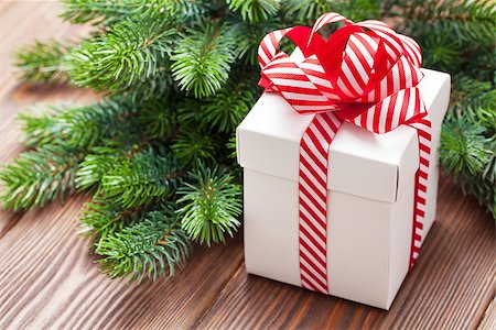 simsearch:400-04241664,k - Christmas gift box and fir tree branch on wooden table Stock Photo - Budget Royalty-Free & Subscription, Code: 400-08299738