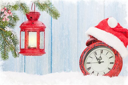 Christmas candle lantern and alarm clock with santa hat Stock Photo - Budget Royalty-Free & Subscription, Code: 400-08299767