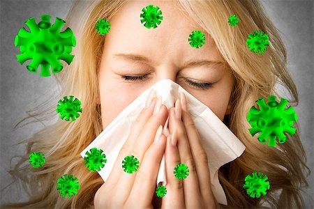 Portrait of a ill blond woman who is sneezing virus  in a tissue Stock Photo - Budget Royalty-Free & Subscription, Code: 400-08299811