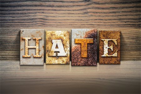 racist - The word "HATE" written in rusty metal letterpress type sitting on a wooden ledge background. Stock Photo - Budget Royalty-Free & Subscription, Code: 400-08290833