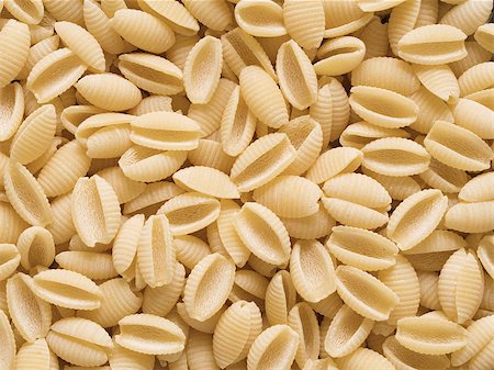 close up of uncooked gnocchetti sardi pasta food background Foto de stock - Royalty-Free Super Valor e Assinatura, Número: 400-08290859