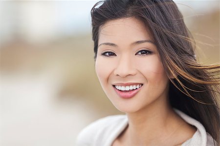 Outdoor portrait of a beautiful young Chinese Asian young woman or girl with perfect teeth Stock Photo - Budget Royalty-Free & Subscription, Code: 400-08291182