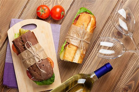 simsearch:400-07937807,k - Two sandwiches and white wine on wooden table. Top view Photographie de stock - Aubaine LD & Abonnement, Code: 400-08291190