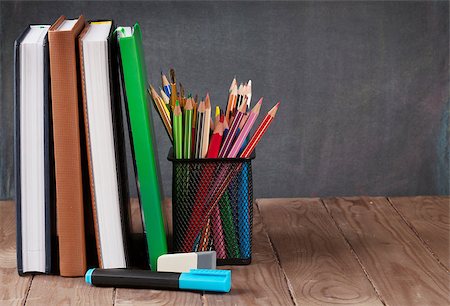 simsearch:400-08289551,k - School and office supplies on classroom table in front of blackboard. View with copy space Stock Photo - Budget Royalty-Free & Subscription, Code: 400-08291326