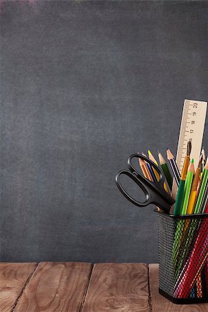 desk with school supplies - School and office supplies on classroom table in front of blackboard. View with copy space Photographie de stock - Aubaine LD & Abonnement, Code: 400-08291328