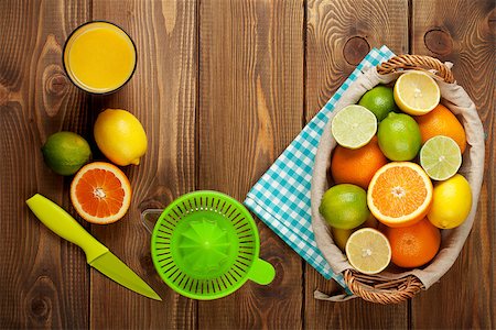 Citrus fruits and glass of juice. Oranges, limes and lemons. Top view over wood table background Stock Photo - Budget Royalty-Free & Subscription, Code: 400-08291447