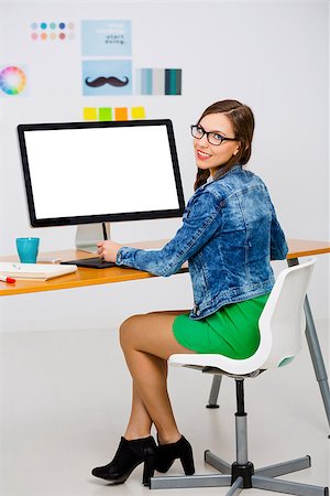Woman working at desk In a creative office, using a computer Stock Photo - Budget Royalty-Free & Subscription, Code: 400-08292230