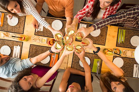 simsearch:400-08292251,k - Group of people toasting and looking happy at a restaurant Stock Photo - Budget Royalty-Free & Subscription, Code: 400-08292250