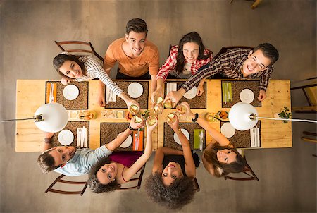 simsearch:400-08292251,k - Group of people toasting and looking happy at a restaurant Stock Photo - Budget Royalty-Free & Subscription, Code: 400-08292253