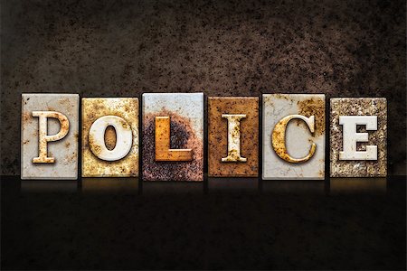 The word "POLICE" written in rusty metal letterpress type on a dark textured grunge background. Stock Photo - Budget Royalty-Free & Subscription, Code: 400-08293189