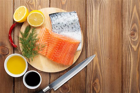 simsearch:400-08187570,k - Salmon, spices and condiments on wooden table. Top view with copy space Stockbilder - Microstock & Abonnement, Bildnummer: 400-08293252